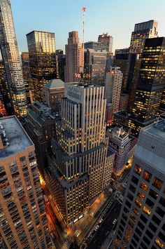 an aerial view of skyscrapers in the city at night, taken from high up