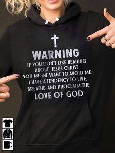 a woman wearing a black hoodie that says warning if you don't like hearting about jesus christ you might want to avoid