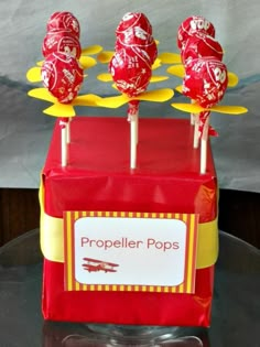 some lollipops sitting on top of a red box