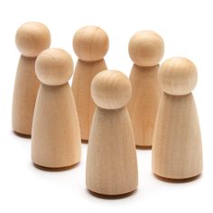 several wooden peg dolls lined up in a row