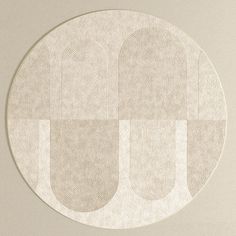 a round white rug with two circles on the bottom and one circle in the middle