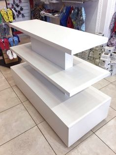 three white shelves stacked on top of each other