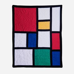 a black and white quilt with multicolored squares on it