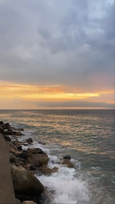 a person walking along the beach with an umbrella