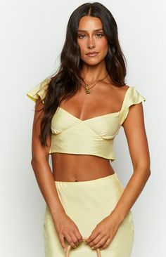 * Yellow Crop Top 
 * Look super feminine and chic in the Anna two piece set (). Gold jewellery () compliments this yellow so well! Utilise the top for a more casual occasion and pair with denim ().  
 * 
 
 * Short sleeves 
 * Cropped length 
 * Invisible zipper (left side) 
 * Seam under bust 
 * Elasticated straps 
 * Tie up back 
 * Non stretch material 
 * Unlined  
 * Slightly sheer Prom Midi Dress, 60's Dress, Summer Playsuit, Yellow Crop Top, Semi Formal Dresses, Beginning Boutique, Yellow Top, Strapless Tops, Long Crop Top