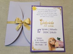 a purple and yellow wedding card with a gold bow on the front, and an image of rappui