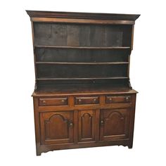 an old wooden cabinet with two doors and drawers