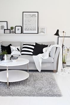 a living room with white furniture and black and white decor on the walls in japanese