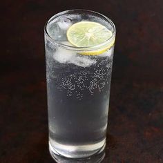 a glass filled with water and a lemon slice