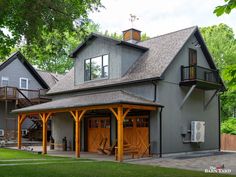 a large gray house with two garages on each side