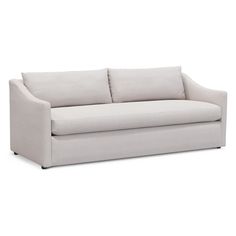 a white couch sitting on top of a white floor