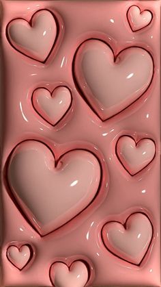 some hearts are in the middle of a chocolate molding sheet that looks like it is made out of fondant