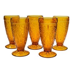 six yellow glass cups sitting next to each other