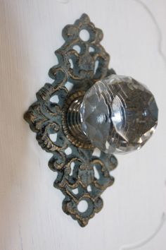 an antique door handle with a glass knob