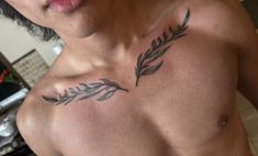 a man with a feather tattoo on his chest