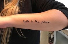 a woman with a tattoo on her arm that says faith in the future