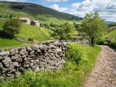 a stone wall in the middle of a field