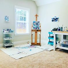 an artist's studio with easel, paintbrushes and other art supplies