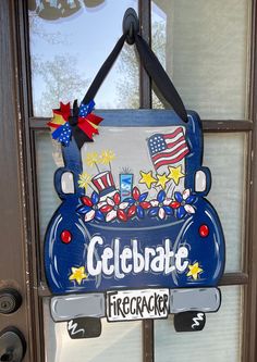 a sign that says celebrate firecracker hangs on the front door to welcome visitors