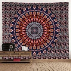 a large tapestry hanging on the wall in a room with wooden flooring and furniture