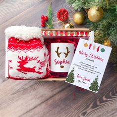 a christmas gift set in a wooden box next to a card and other holiday decorations