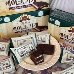 some chocolate bars are sitting on a plate and in front of several packages of them