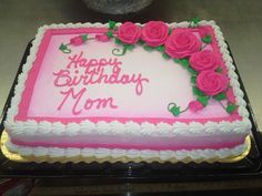 a pink and white birthday cake with roses on it