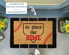 a baseball themed door mat that says no place like home