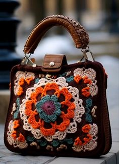 a crocheted purse sitting on top of a sidewalk