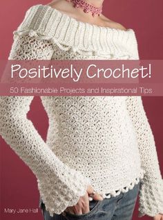 a woman wearing a white sweater with the words positively crochet on it