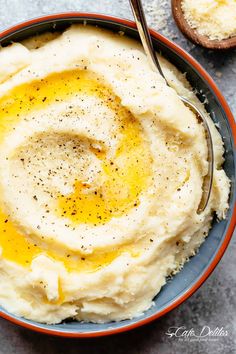 a bowl filled with mashed potatoes topped with an egg and seasoning on top