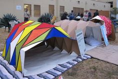 an outdoor tent with people standing around it