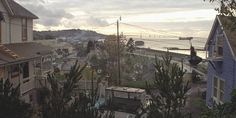 a view of some houses and the ocean in the distance