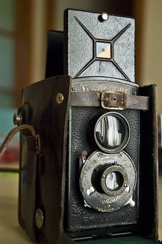 an old camera sitting on top of a table