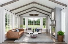 a living room filled with furniture and a fire place in the middle of an open floor plan