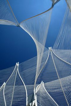 the underside view of an artistic sculpture against a blue sky