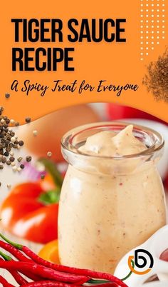 tiger sauce recipe in a glass jar with red peppers and other ingredients around it on an orange background