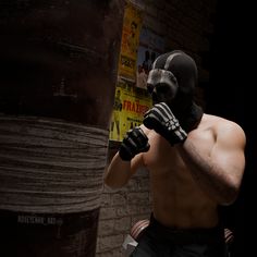 a man wearing a mask and gloves standing in front of a brick wall with posters on it