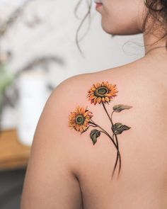 a woman with a sunflower tattoo on her back