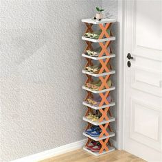 the shoe rack is made out of wood and has multiple sections for shoes to hang on