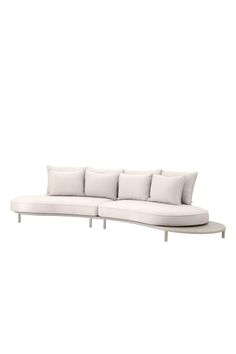 a white couch with four pillows on the back and one arm extended to the side