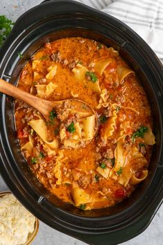 a crock pot filled with pasta and meat