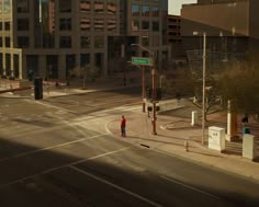 a person standing on the corner of an empty street