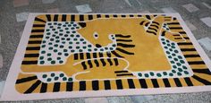 a yellow tiger rug on the floor with black and white stripes around it's body