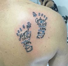 the back of a man's left shoulder with his family names tattooed on it