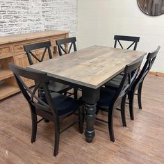 a dining room table and chairs with a brick wall in the background