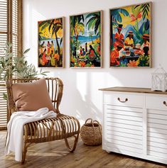 three paintings hang on the wall next to a chair and table with a plant in it