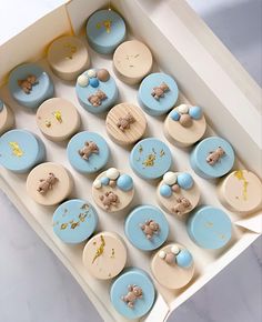 a box filled with lots of blue and white cake items on top of a table