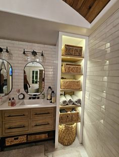 a bathroom with two sinks and baskets on the shelves