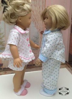 two dolls are standing next to each other